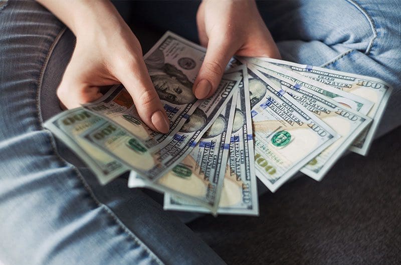 What-is-an-Express-Business-Loan Two hands holding currency notes