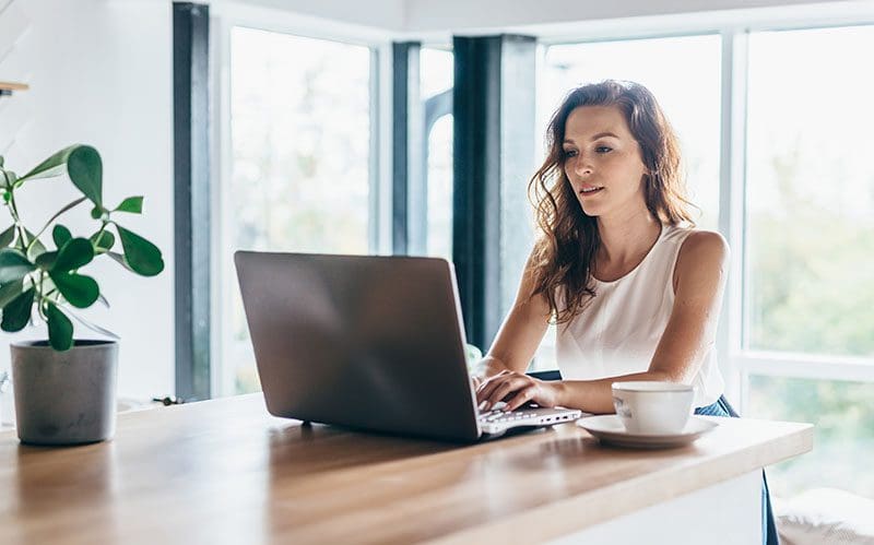 Choosing-a-Business-Domain-Name A woman working on a laptop