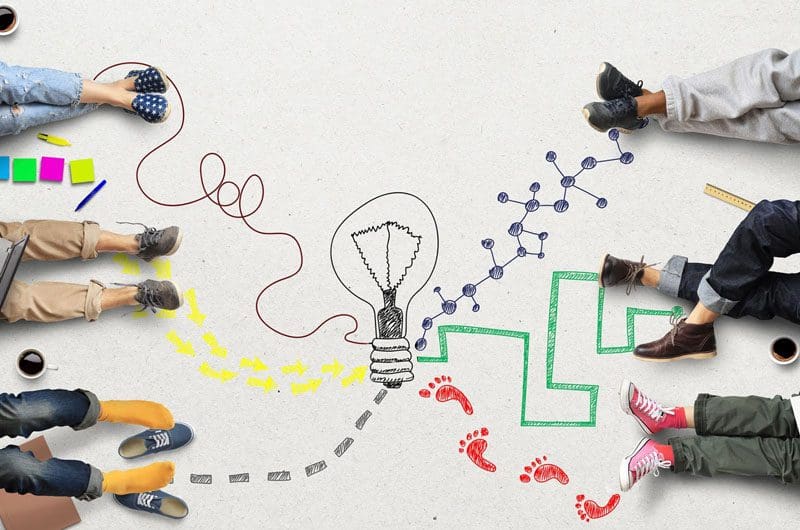 Why-Creativity-Is-Essential-to-Getting-Your-New-Businesses-Started-in-a-Winning-Position people sitting around a light bulb