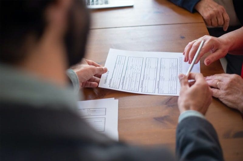 reasons-why-you-might-need-to-apply-for-a-business-loan A man offering a pen to someone